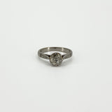 Straight-on view of antique platinum solitaire ring with old-cut diamond in eight-claw setting
