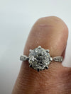 Antique platinum old-cut diamond solitaire ring worn on the hand, showing the eight-claw setting