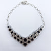 Reverse view of sterling silver black onyx necklace showing bezel backs, chain links and clasp