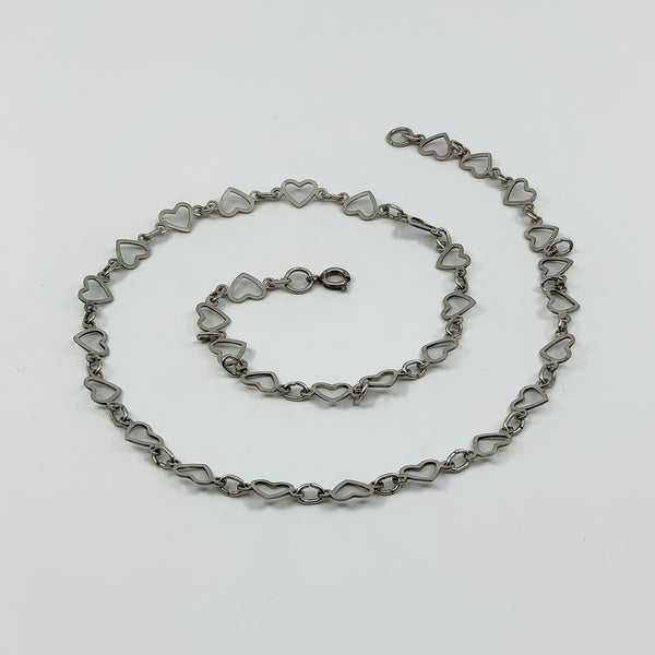 Vintage sterling silver open heart link necklace laid flat, showing the full chain design