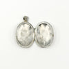 Open sterling silver oval photo locket showing the plain interior and hinge