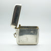 Antique silver vesta case with open hinged lid showing interior