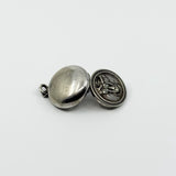 Open vintage sterling silver Virgin Mary photo locket showing plain back and raised religious detail.