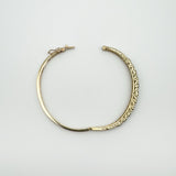 Vintage oval bangle open showing push clasp and scroll pattern