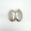 Chunky sterling silver locket opened to show front engraving and plain back