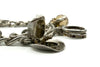 Close up of opening cowboy hat charm on vintage sterling silver charm bracelet with aged silver detail.