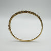 Raised floral design on vintage 9ct gold emerald bangle