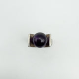 Overhead view showing amethyst ball set between thick silver shoulders