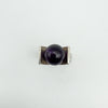 Overhead view showing amethyst ball set between thick silver shoulders