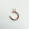 Overhead view of antique horseshoe pendant with ruby and diamond detail