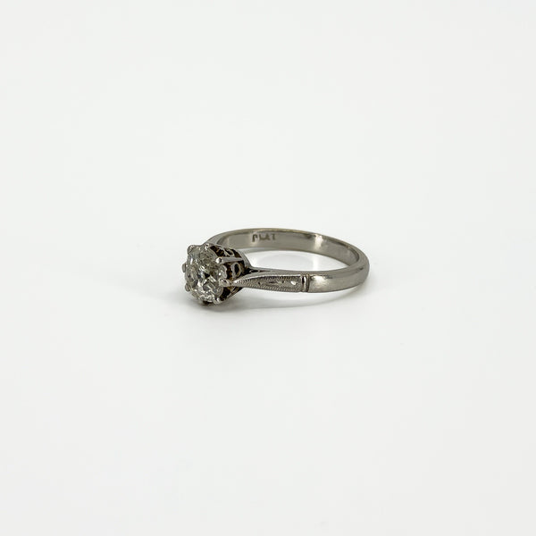 Side view of antique platinum diamond solitaire ring with PLAT stamp visible inside the band