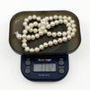 New freshwater baroque pearl necklace on digital scales weighing approximately 33.7g