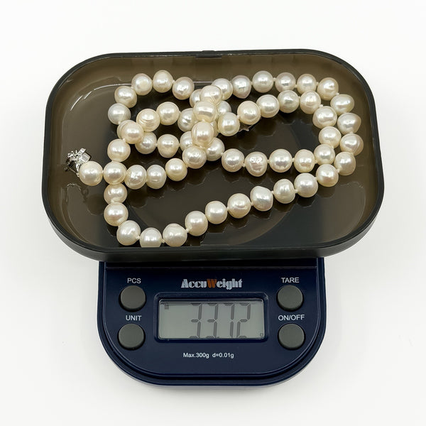 New freshwater baroque pearl necklace on digital scales weighing approximately 33.7g