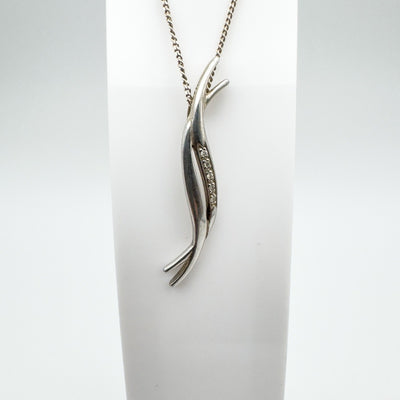 Curved sterling silver diamond pendant on chain shown upright