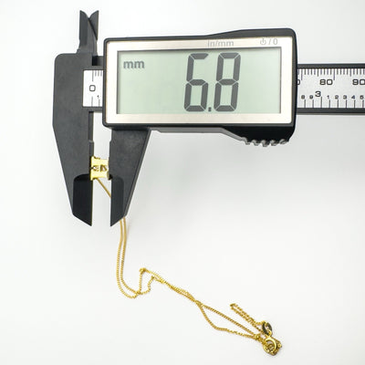 Height of vermeil initial H pendant measuring 6.8mm on calipers