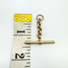 Vintage gold T-bar pendant with belcher link shown against tape for scale