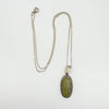 Full flat lay of vintage sterling silver chain and Connemara pendant necklace