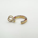 View of ruby and diamond horseshoe pendant showing depth and gold finish
