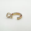 View of ruby and diamond horseshoe pendant showing depth and gold finish