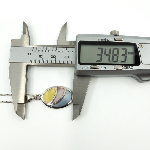 Digital caliper measuring oval pendant length at approximately 34.83mm, sterling silver inlay necklace.