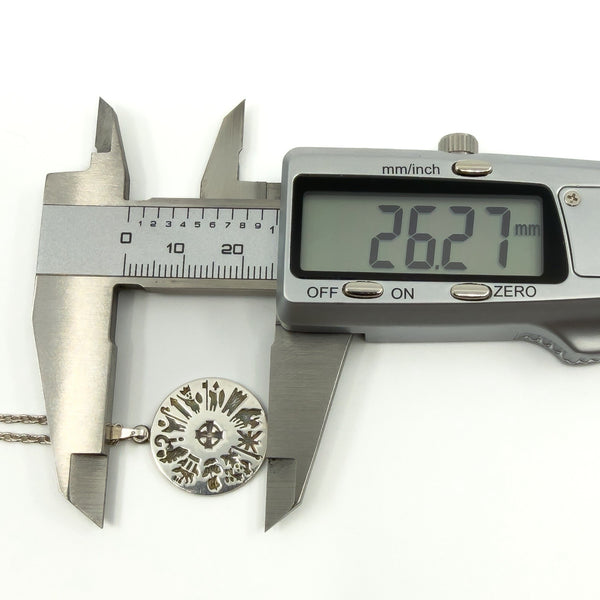 Digital calipers showing 26.27mm length on History of Ireland sterling silver pendant.