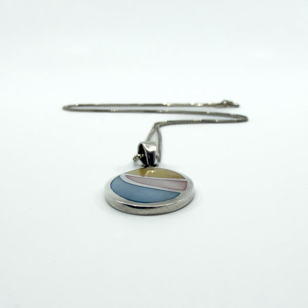 Sterling silver oval inlay pendant with box chain laid flat, showing drop and overall proportion.