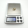 Vintage 9ct gold CZ heart pendant photographed on digital scale weighing 1.05 grams.