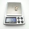 Sterling silver Christian cross pendant on digital scale weighing 5.28 grams
