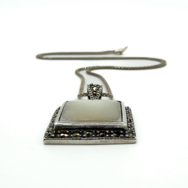 Sterling silver mother of pearl marcasite pendant side view, showing raised setting on chain.