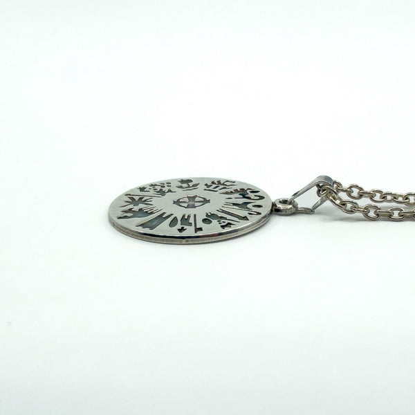 Side view of sterling silver History of Ireland pendant showing thickness and bail, chain attached.