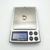 Digital scale showing ruby and diamond horseshoe pendant weight at 0.96g