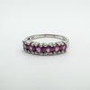 Angled view of pink rhodolite garnet ring with smooth polished sterling silver band