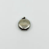 Plain back of vintage sterling silver Virgin Mary photo locket pendant showing surface wear.