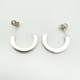 Reverse side of earrings showing smooth polished silver backs without stones