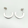 Reverse side of earrings showing smooth polished silver backs without stones