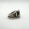 Angled view showing plaited band and detailed flower on sterling silver ring