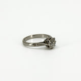 Side profile of antique platinum old-cut diamond solitaire ring with engraved shoulder detail