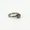 Side profile of antique platinum old-cut diamond solitaire ring with engraved shoulder detail