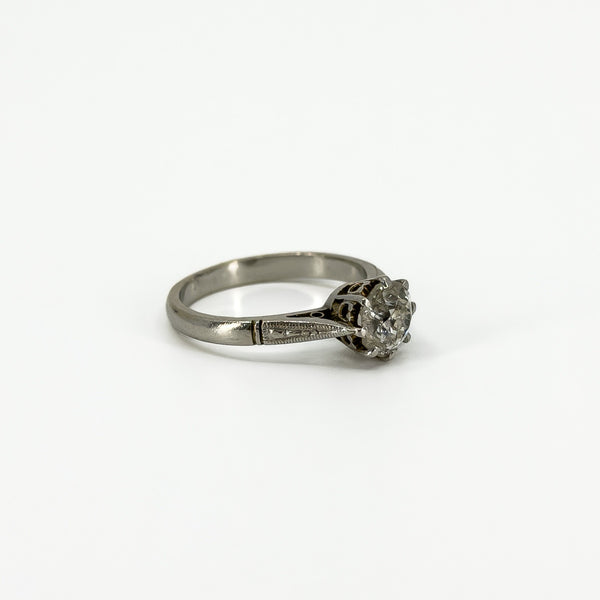 Side profile of antique platinum old-cut diamond solitaire ring with engraved shoulder detail