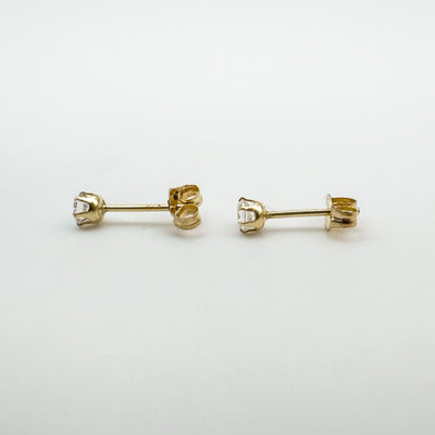 Preloved 9ct gold CZ stud earrings with round cut stones and butterfly backs side