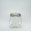 Sterling silver ring featuring a row of princess-cut Moissanites in a secure channel setting, displayed on a clear stand