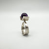 Profile view of bold vintage ring with purple amethyst and wide silver band