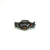 Low profile view of giardinetti brooch showing the basket shape, paste settings and marcasite detail.