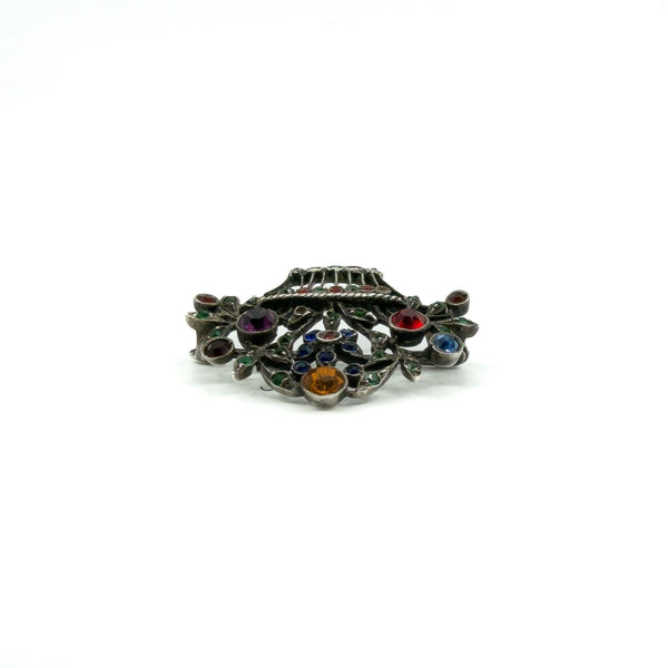 Low profile view of giardinetti brooch showing the basket shape, paste settings and marcasite detail.