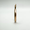 Edge profile of Edwardian 9ct gold photo locket showing rounded band and depth