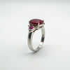 Angled upright view showing raised oval ruby and side rubies