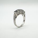 Angled side view of filigree shoulder detail and sapphire setting