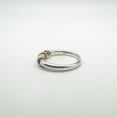 Rear side of silver ring showing gold wire and hallmarks