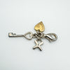 Reverse view of cross, heart and key charms with sterling clasp
