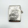Reverse side showing ornate scroll engraving on antique silver Vesta Case